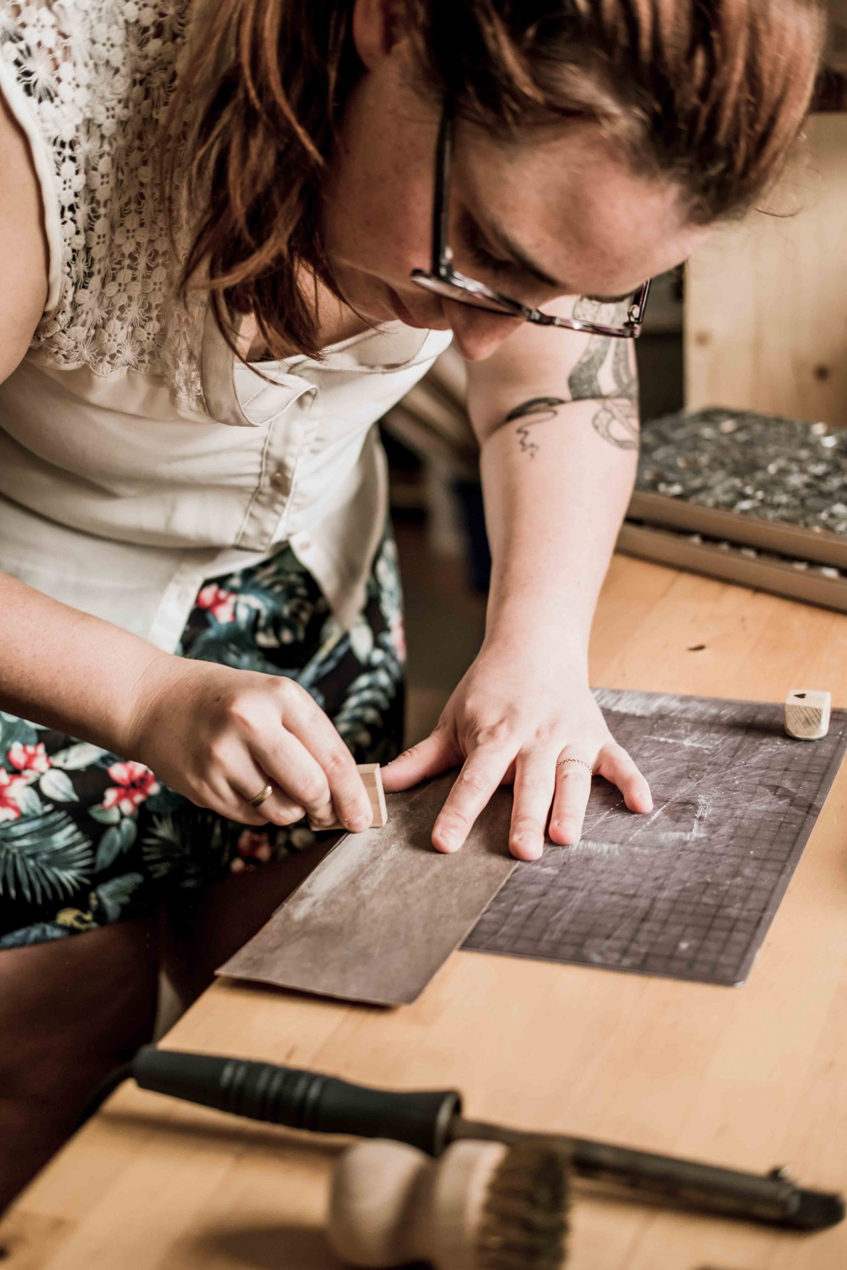 Lotte sands her wooden stamps