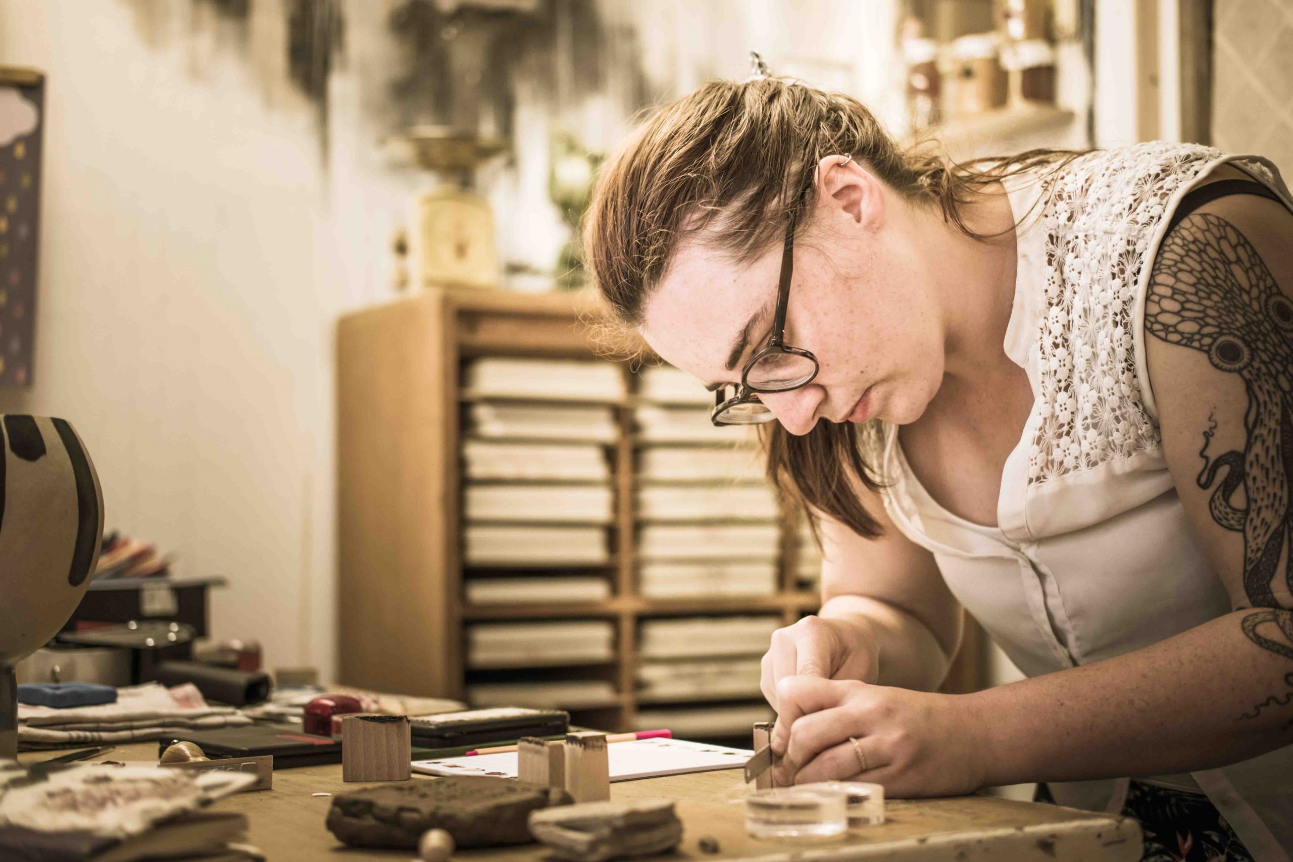 Lotte saws the wooden stamp